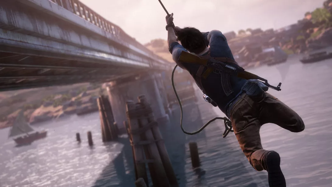 Nate köyden varassa osumassa siltaan (Uncharted 4)